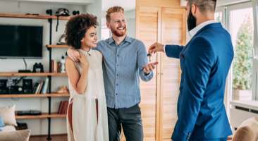 couple receiving keys to their new home