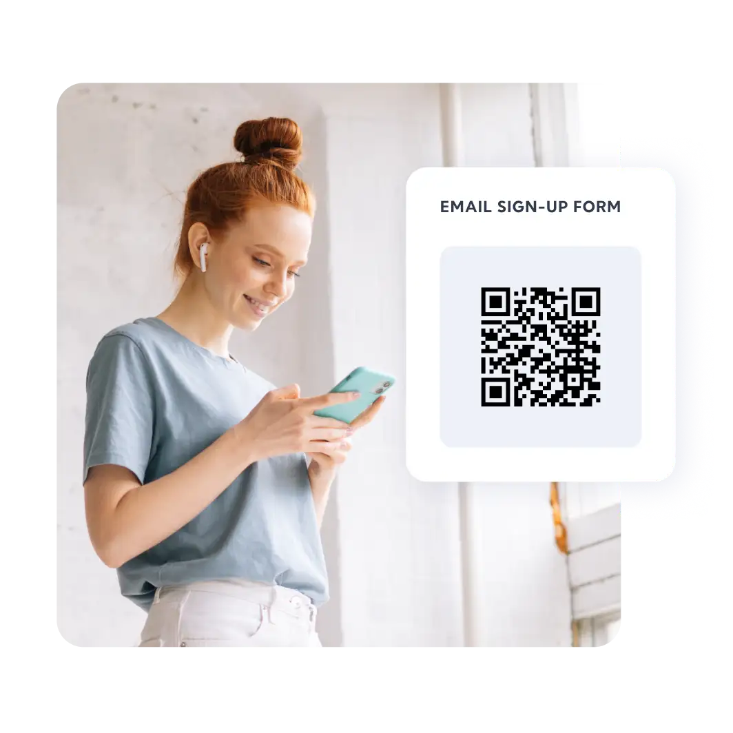 Woman with red hair smiling at her phone next to an email sign-up form QR code card.