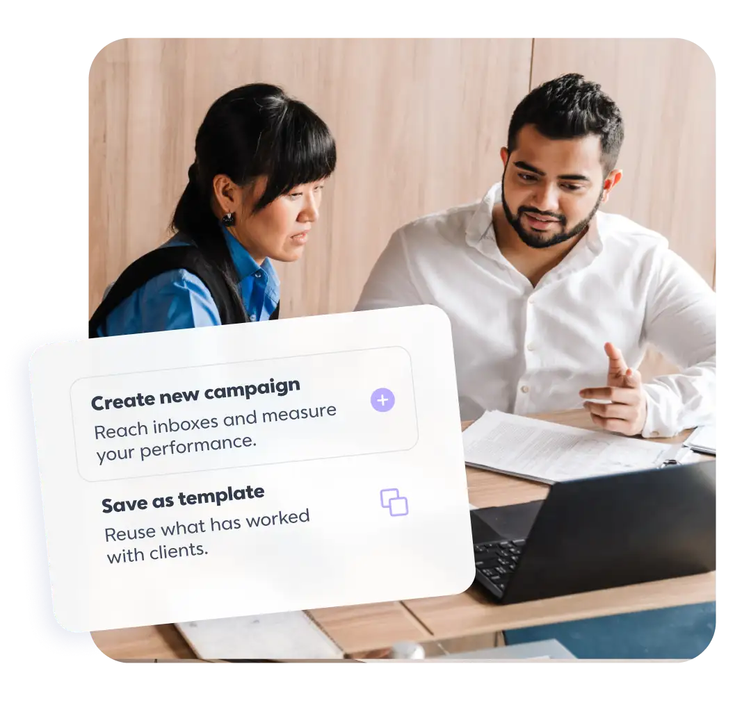 White UI card with two options: "Create new campaign" and "Save as template" with descriptions. In the background, a man and a woman are seated at a wooden table looking toward a laptop and physical documents.
