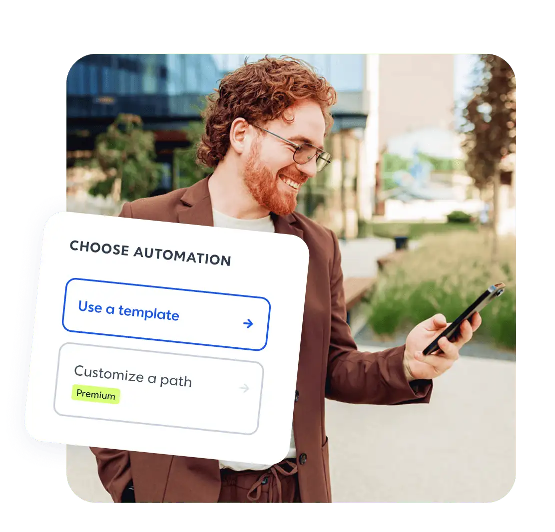 Smiling man with curly red hair using a smartphone outdoors, with a Choose Automation UI overlay showing template options.