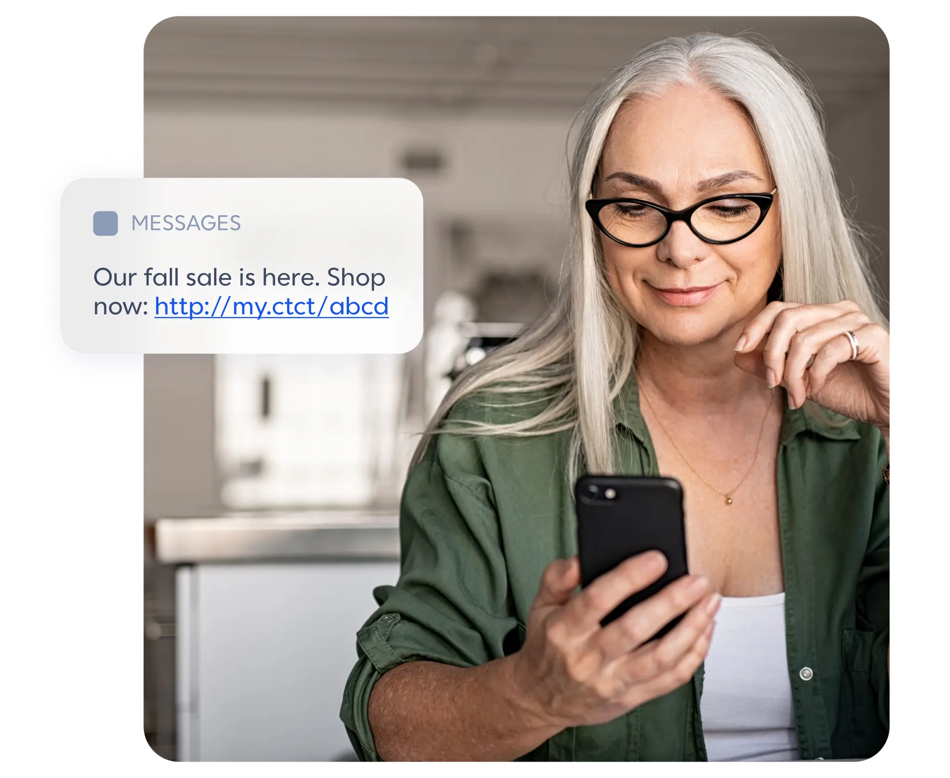 A woman looking at her phone regarding a fall sale offer