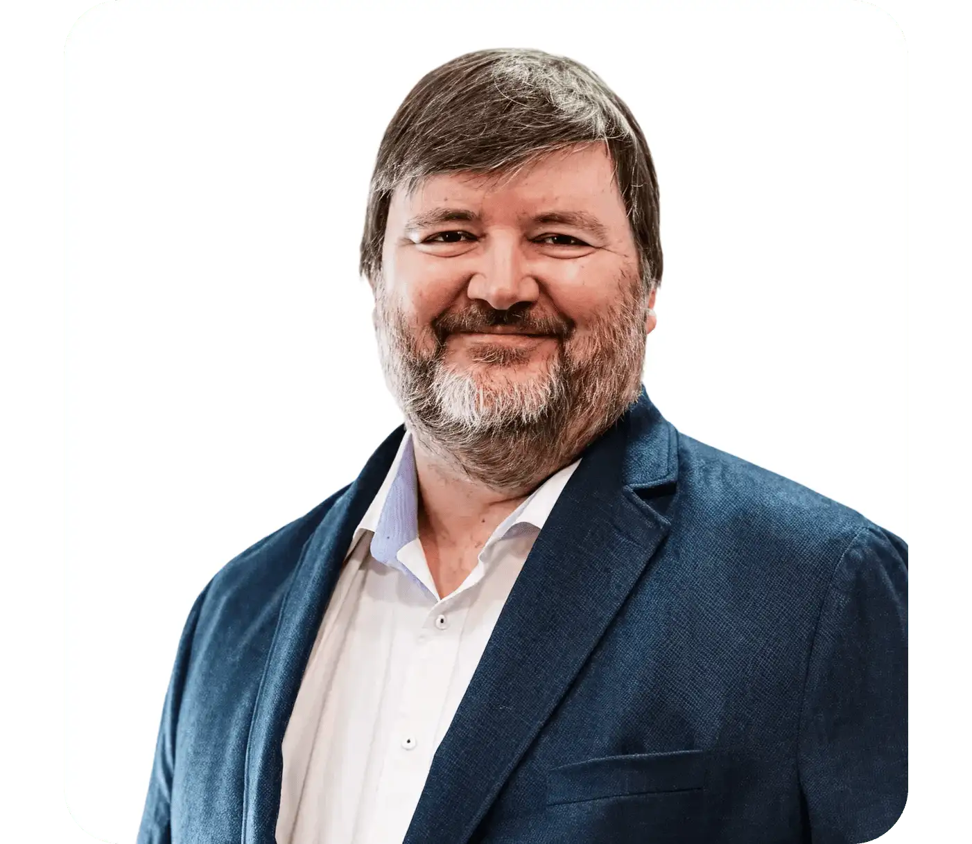 Professional portrait of a smiling person with a beard wearing a navy blue blazer and white shirt against white background.