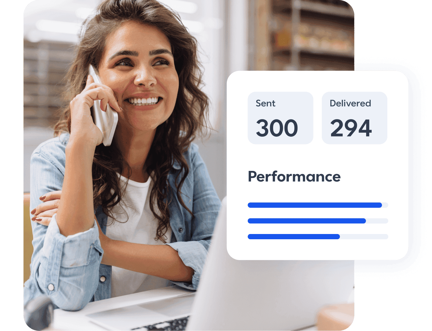 Business woman on the phone and smiling at her laptop with a view of her digital marketing performance within Constant Contact