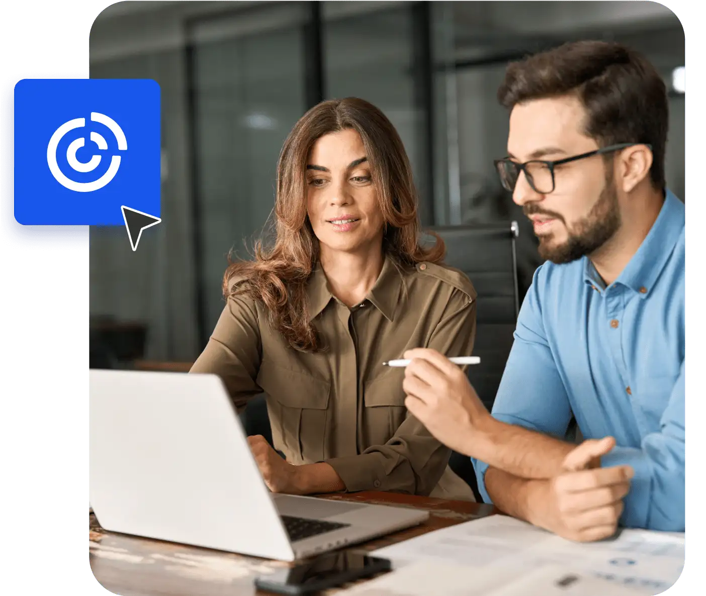 A man and woman sitting and looking at a laptop
