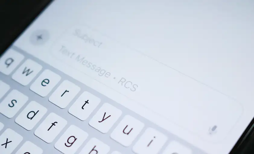 a smartphone in a person's hand with two illustrated text messages