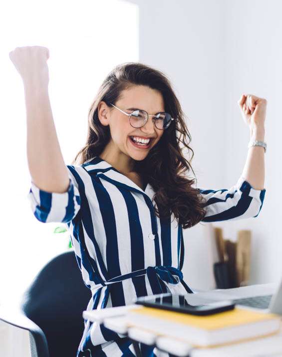 woman holding two fists up in excitement