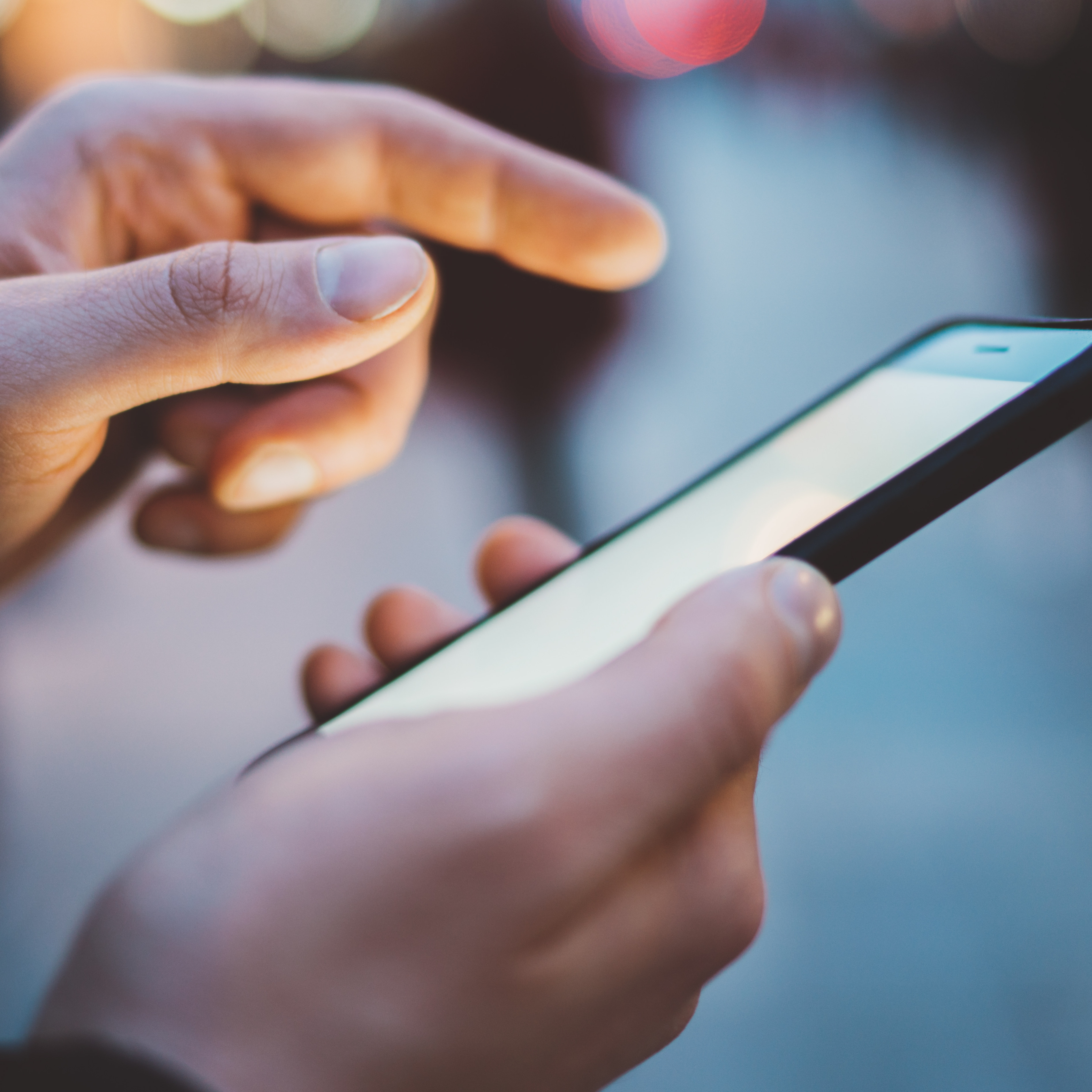 A hand holding a smartphone.