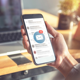 Image showing a person with a smartphone in their hand checking their email notifications