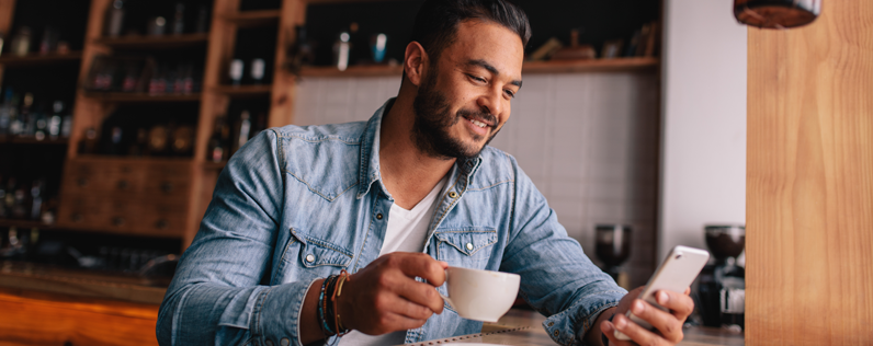 Man on phone with coffee cup featured image