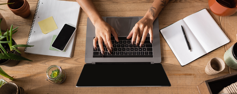 Online marketing for small business header image shopkeeper working at desk