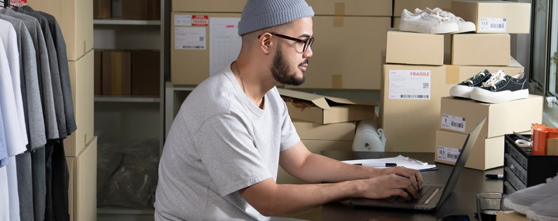 Measure digital marketing blog header Man sitting at desk working on laptop