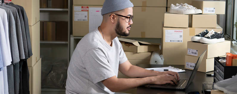 Man sitting at desk working on laptop