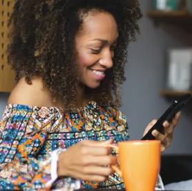 Female business owner on mobile phone with coffee