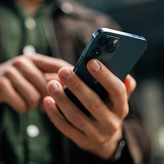 A person holds a smartphone in their hand.