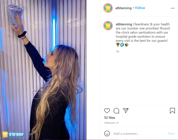 ATB Instagram post featuring an employee cleaning a vertical tanning booth
