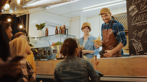 Food truck set up at an event - staff chatting with customers