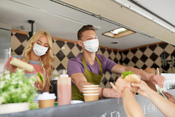 A masked crew working a food truck