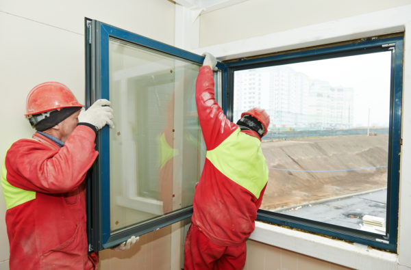 how to start a window installation business - tow installers working on a large window