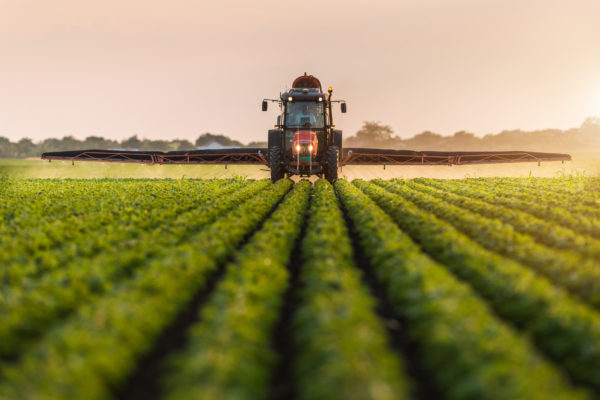 Types of businesses - large tractor spraying crops