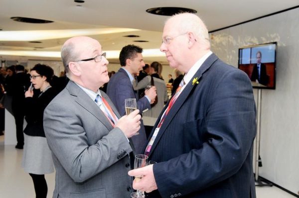Two men possibly swapping IT consulting tips at a networking event