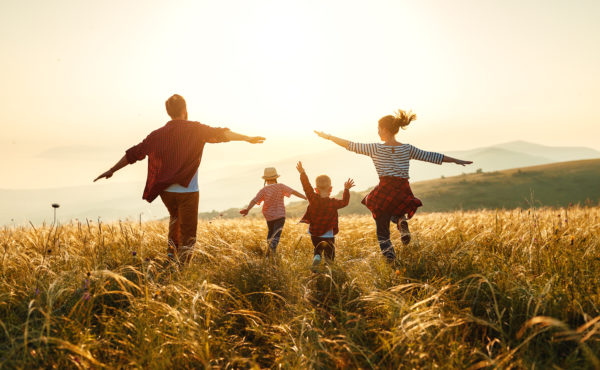 Life Insurance Marketing Ideas - families like this one playing in a field together are why it's important to strike the right tone in your marketing