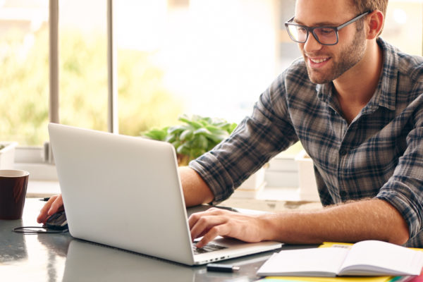 starting a transport and logistics business requires that, like this man, you sit down at your computer and complete all the required legal paperwork and then start applying for financing.