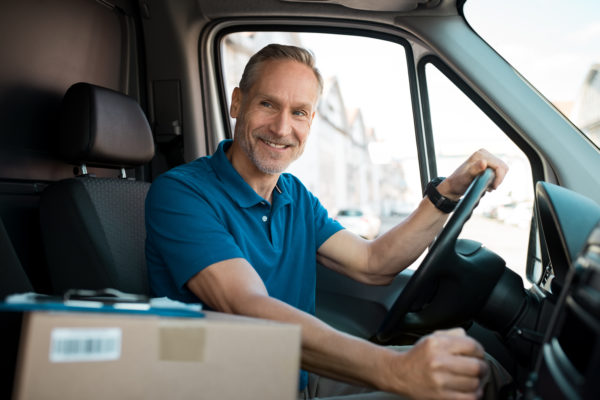 starting a transport and logistics business -- like this local courier in a small van and a package in the passenger seat