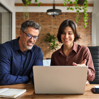 Two professionals on a laptop