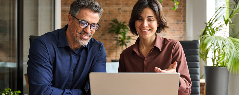 Google Ads Blog header Two professionals on a laptop