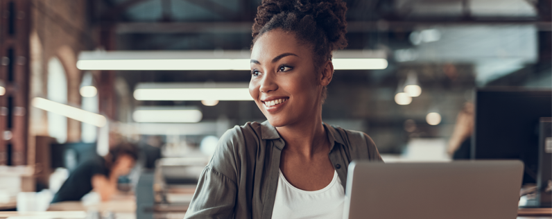 Businesswoman working on laptop, designing an email