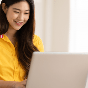 Woman working on email design on laptop