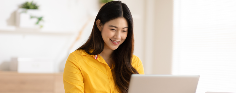 Woman working on email design on laptop