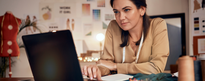 Boutique owner working on laptop