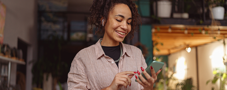 Business owner checking email marketing report on smartphone