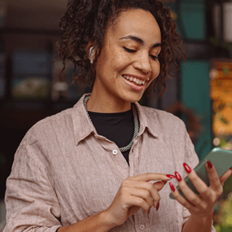 Business owner checking email marketing report on smartphone