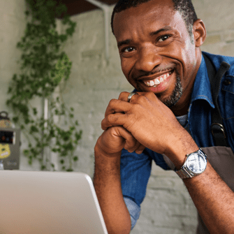 Business owner working on product launch email on laptop