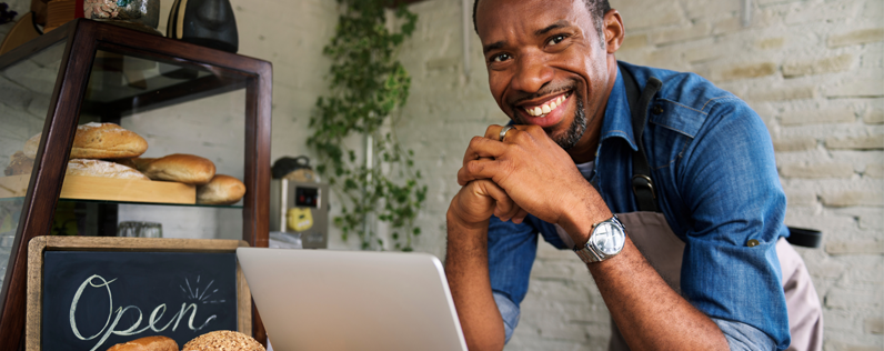 Product Launch Emails Blog header Business owner working on product launch email on laptop