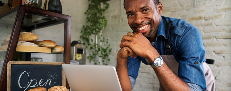 Business owner working on product launch email on laptop