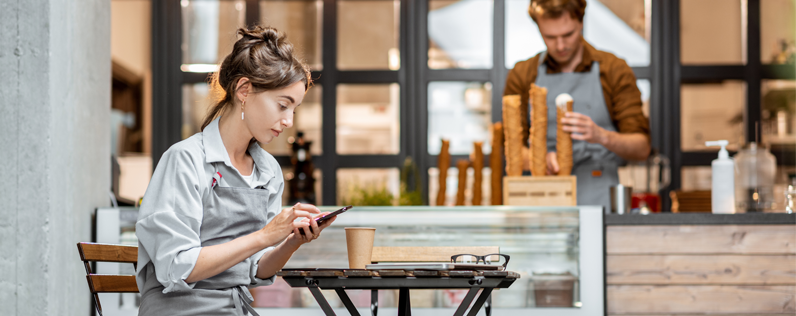 Barista working on sms marketing