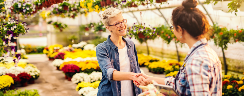 Nursery owner shaking hands with customer