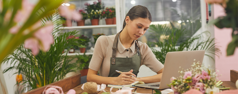 florist at desk with laptop