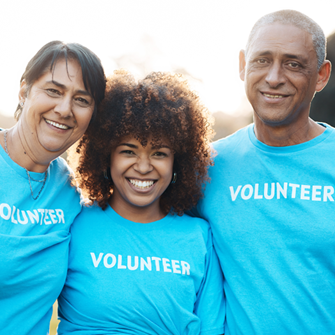 three volunteers dressed in blue
