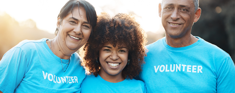 three volunteers dressed in blue