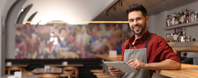 How to Send out Mass Emails A Step-by-Step Guide for Small Businesses Blog header Restaurant owner on ipad