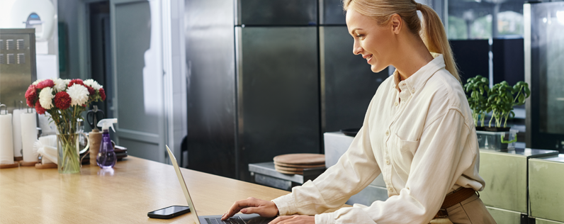 Email Workflow Automation Blog header Female business owner on laptop