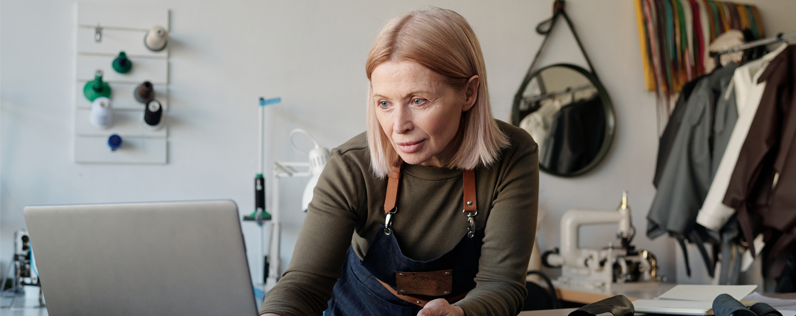 Promotional email examples Blog header Female shop owner on laptop