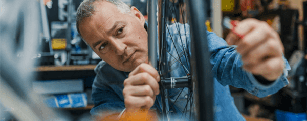 Bike shop owner working on wheel