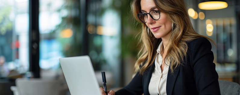 Email Salutations Blog header Female professional on laptop