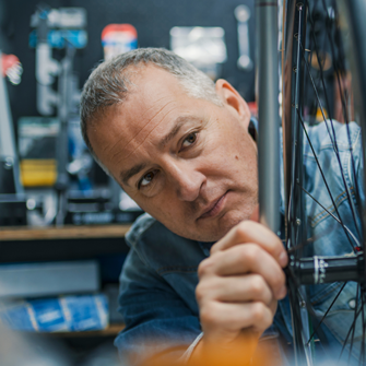 Bike shop owner working on wheel