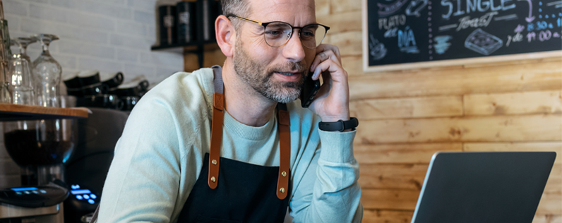 Personalized Email Marketing Blog header Shop owner on laptop and cell phone